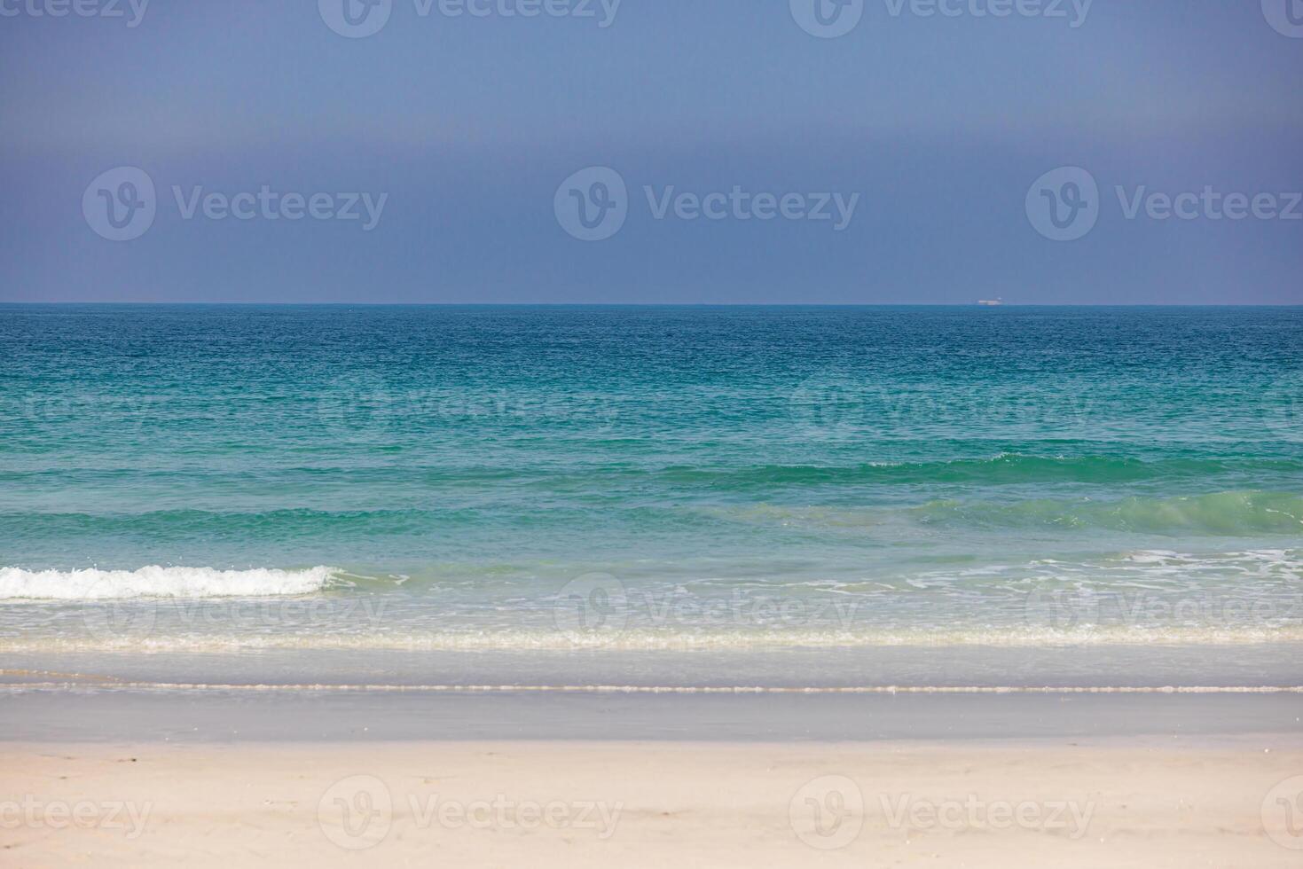 A pristine beach with turquoise waters and golden sand in the UAE photo
