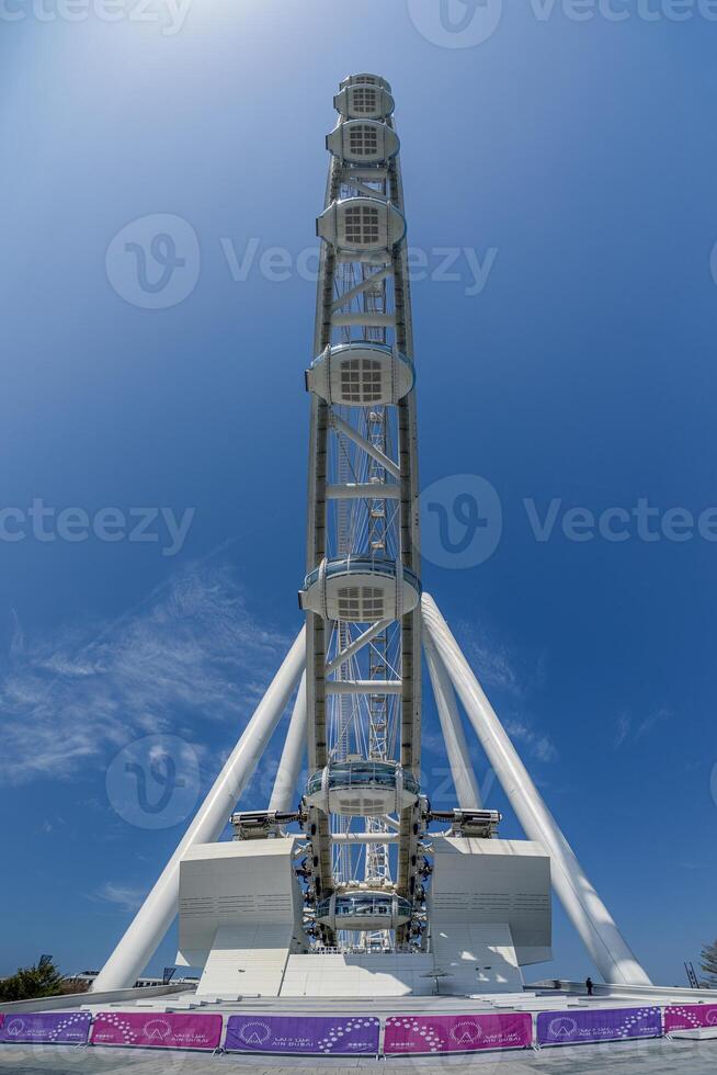 Dubai Marina Ferris wheel viewed from below against blue sky 3 photo