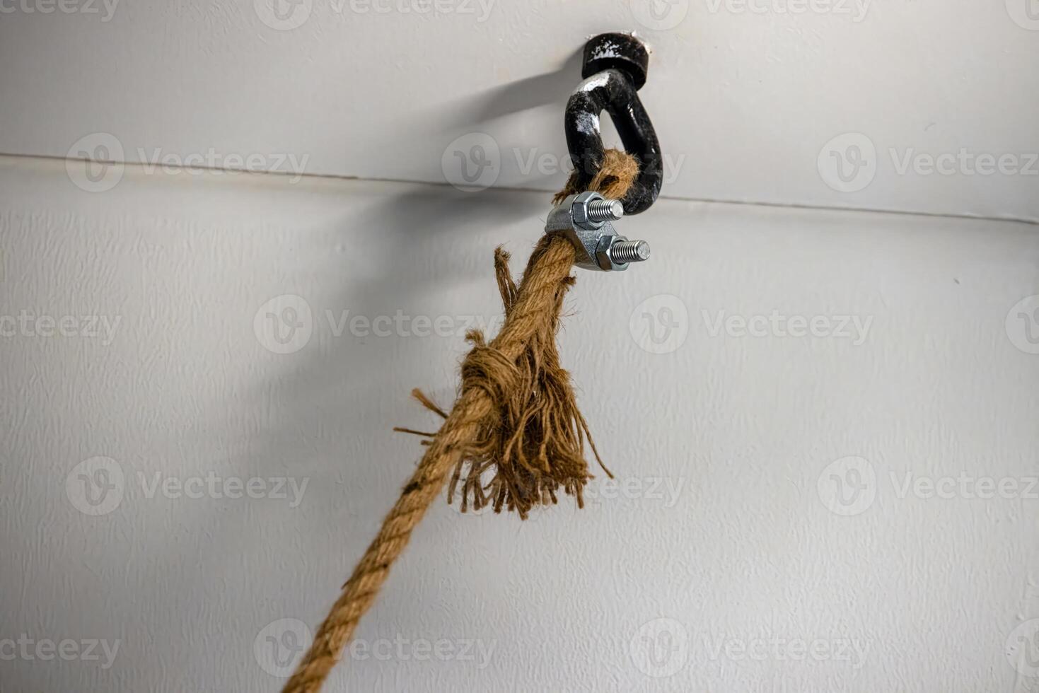 Strong rope knot connection with metal clip in detailed close up with white background 3 photo