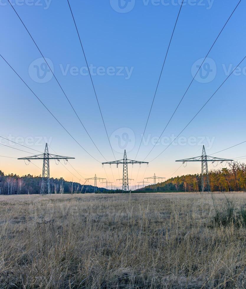 High voltage power lines over a field at sunset 21 photo