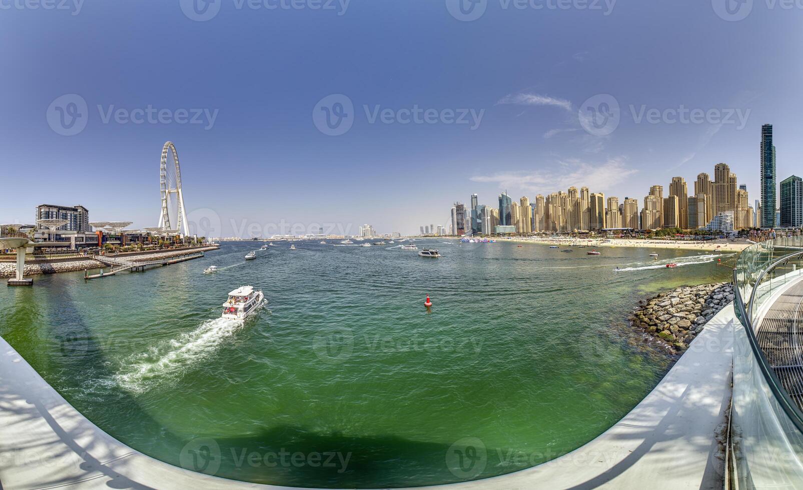 Dubai Marina featuring high rise buildings, a yacht harbor, and a lively promenade 2 photo