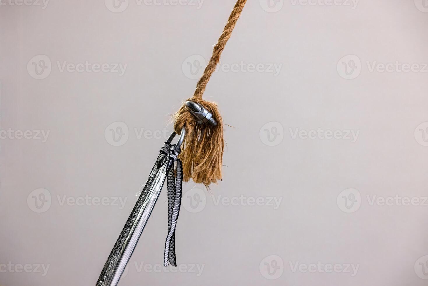 Strong rope knot connection with metal clip in detailed close up with white background 2 photo