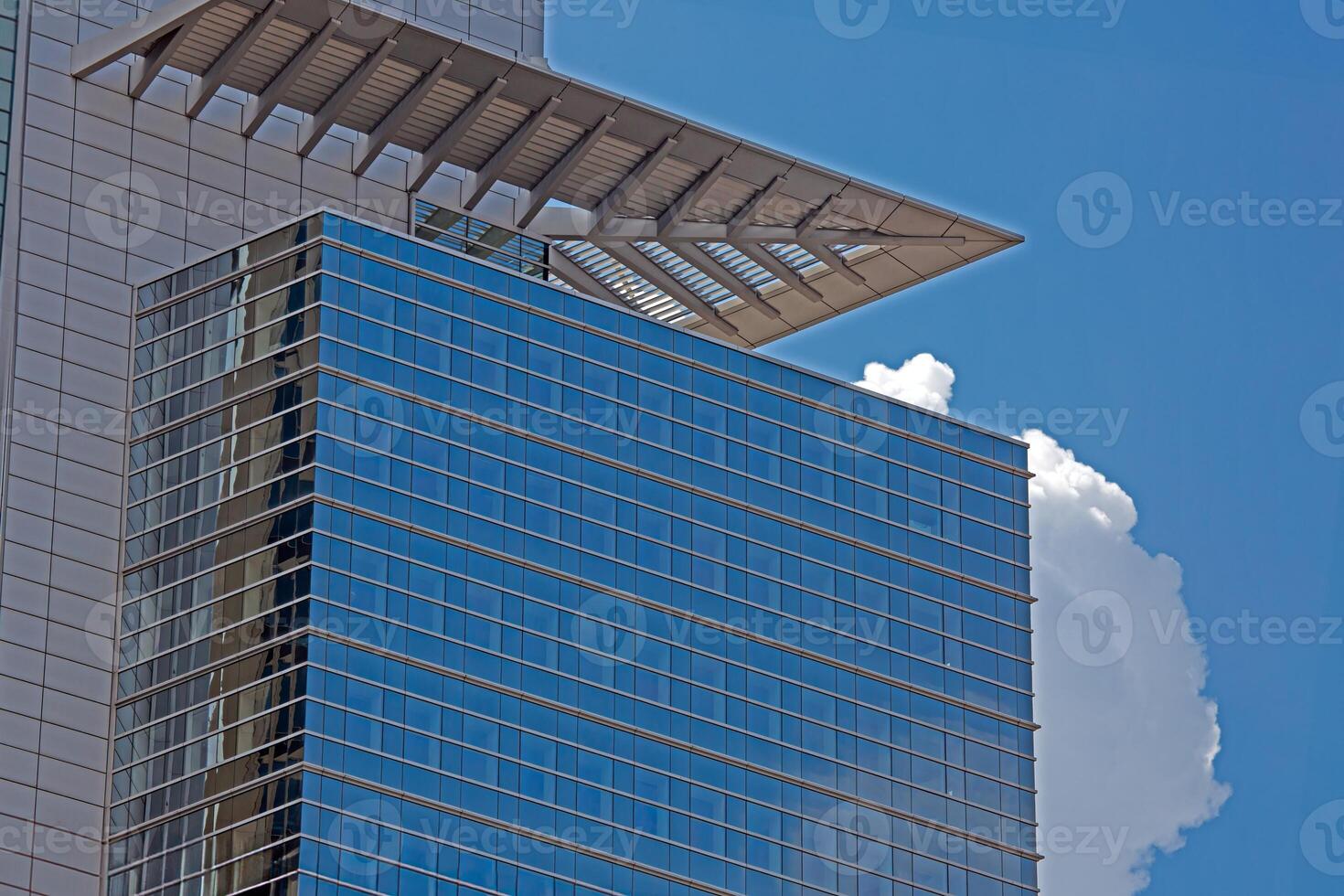 Close up of modern glass facade reflecting blue sky in Frankfurt 7 photo