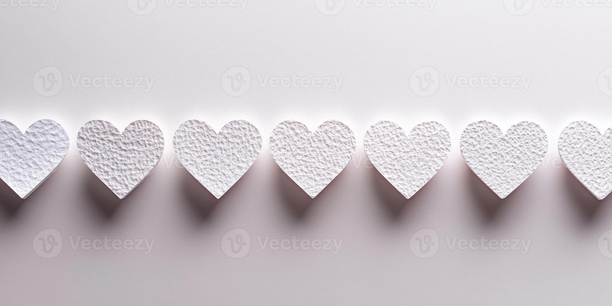 Minimalist textured white heart shapes aligned across a soft gradient background photo