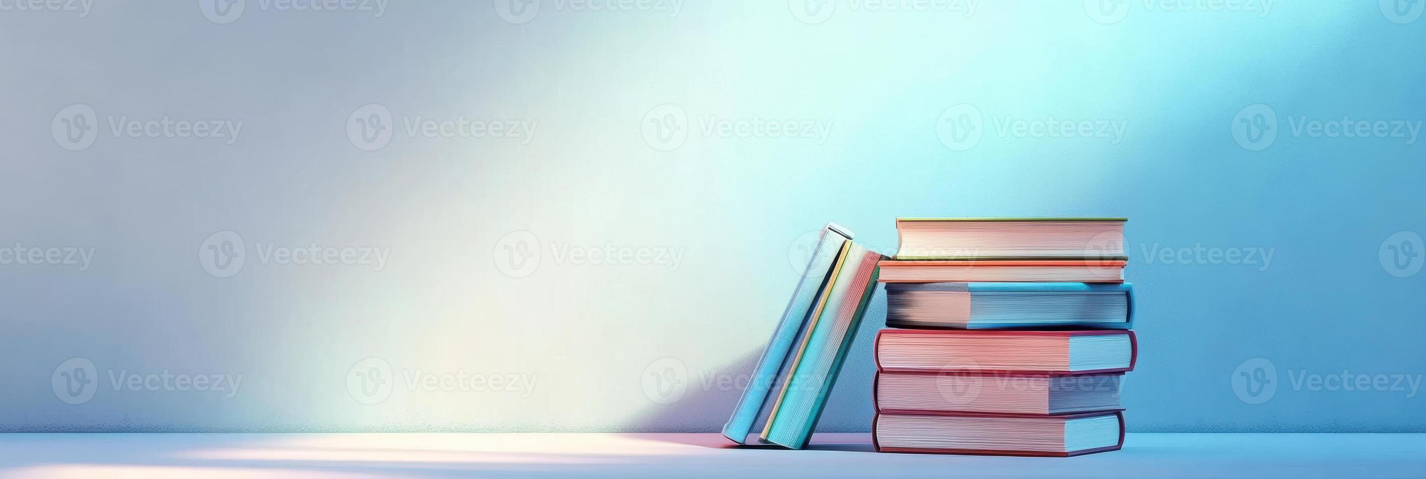 Stack of colorful books leaning against a minimalist background for education concept photo