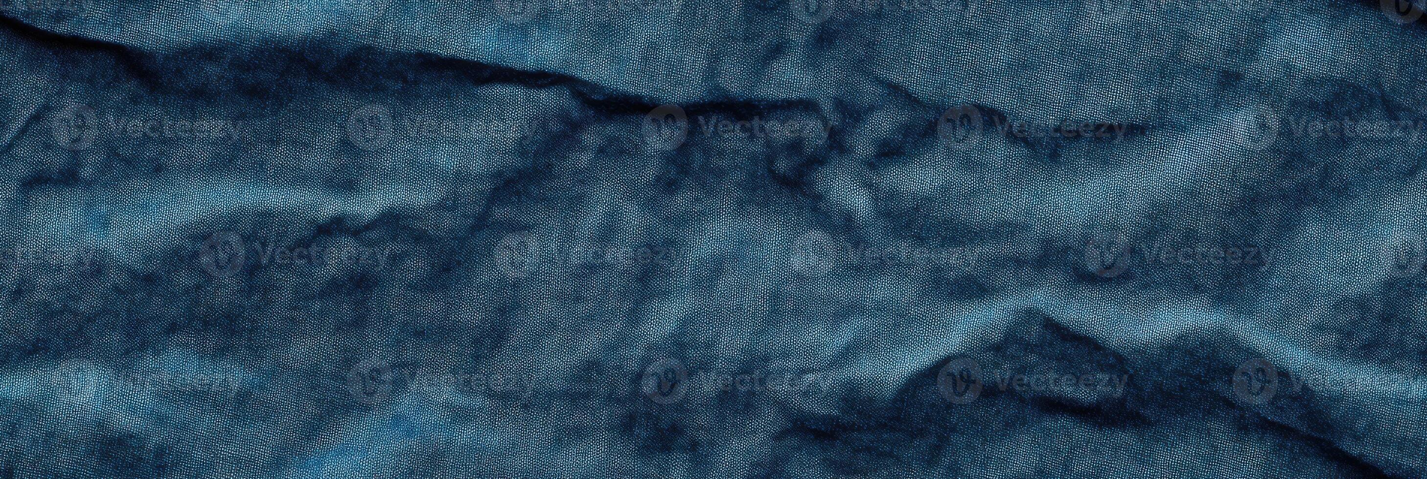 Crumpled blue denim texture fabric wrinkles textured background pattern close-up photo