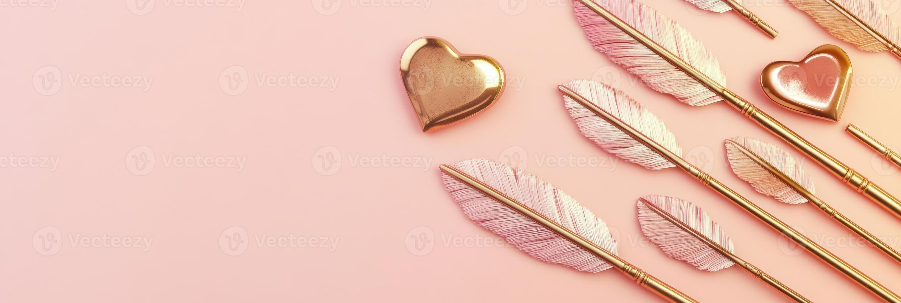Pink background with gold heart and feather pens for romantic and creative concept photo