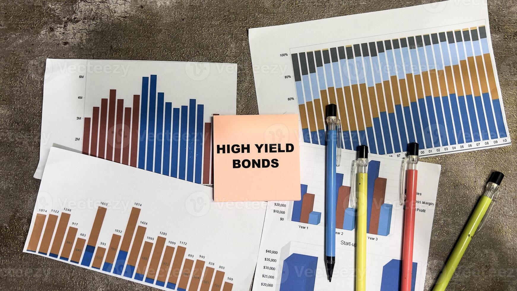 Concept of High Yield Bonds write on book isolated on Wooden Table. photo