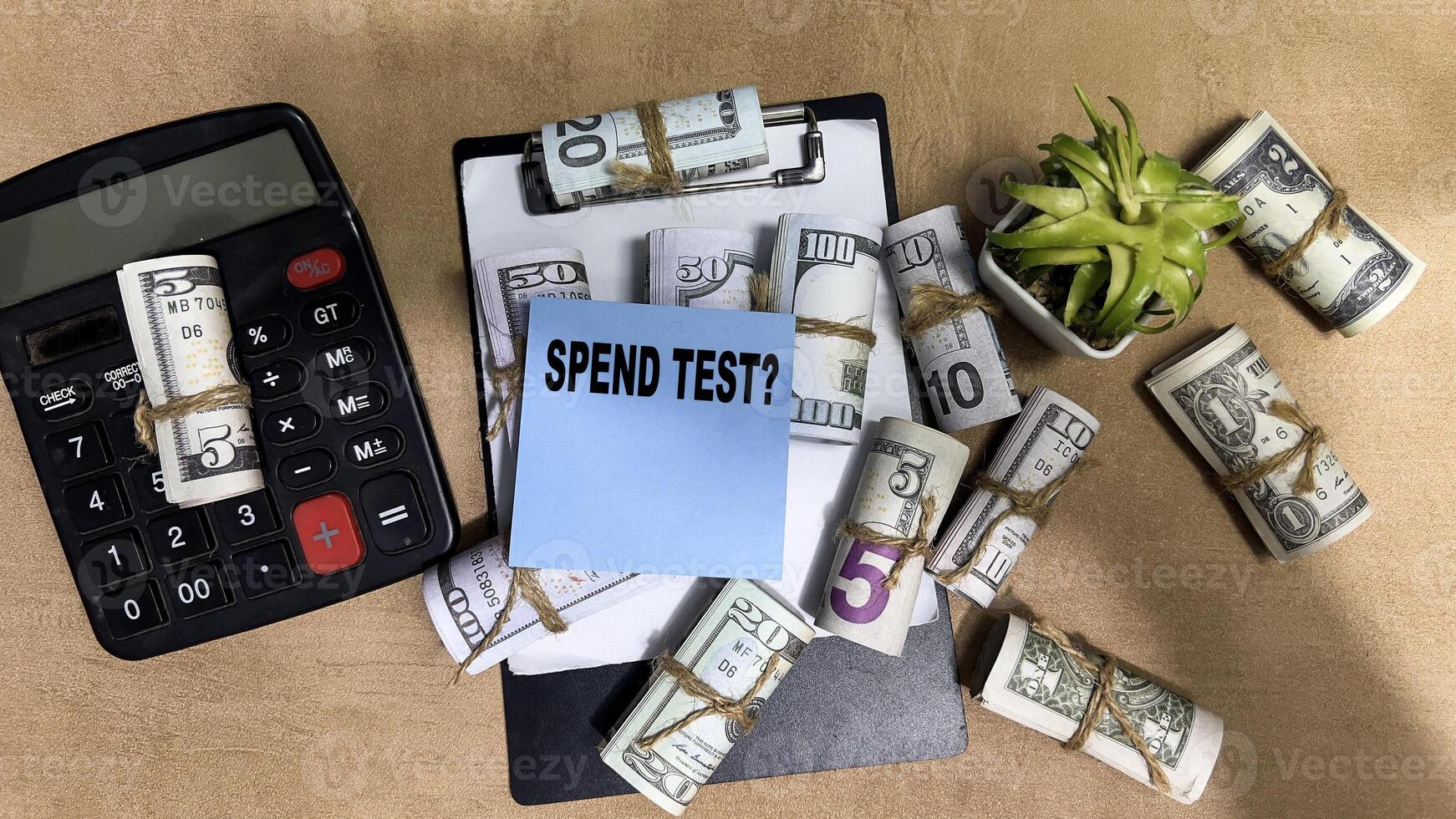 Concept of Spend Test write on sticky notes isolated on Wooden Table. photo
