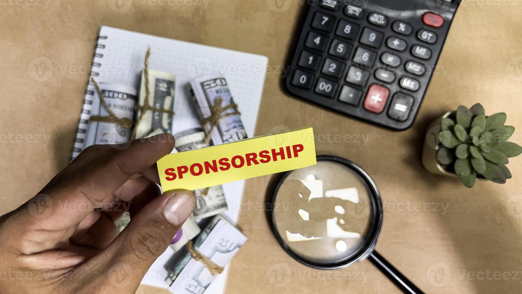 Concept of Sponsorship write on sticky notes isolated on Wooden Table. photo