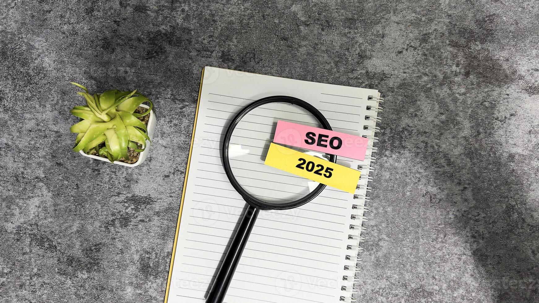 Concept of SEO 2025 write on sticky notes isolated on Wooden Table. photo