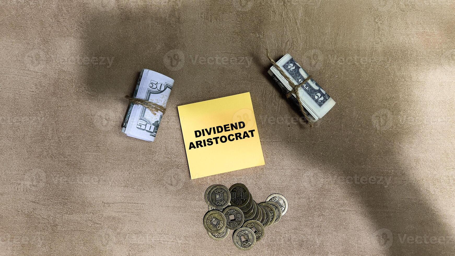 Concept of Dividend Aristrocrat write on sticky notes isolated on Wooden Table. photo
