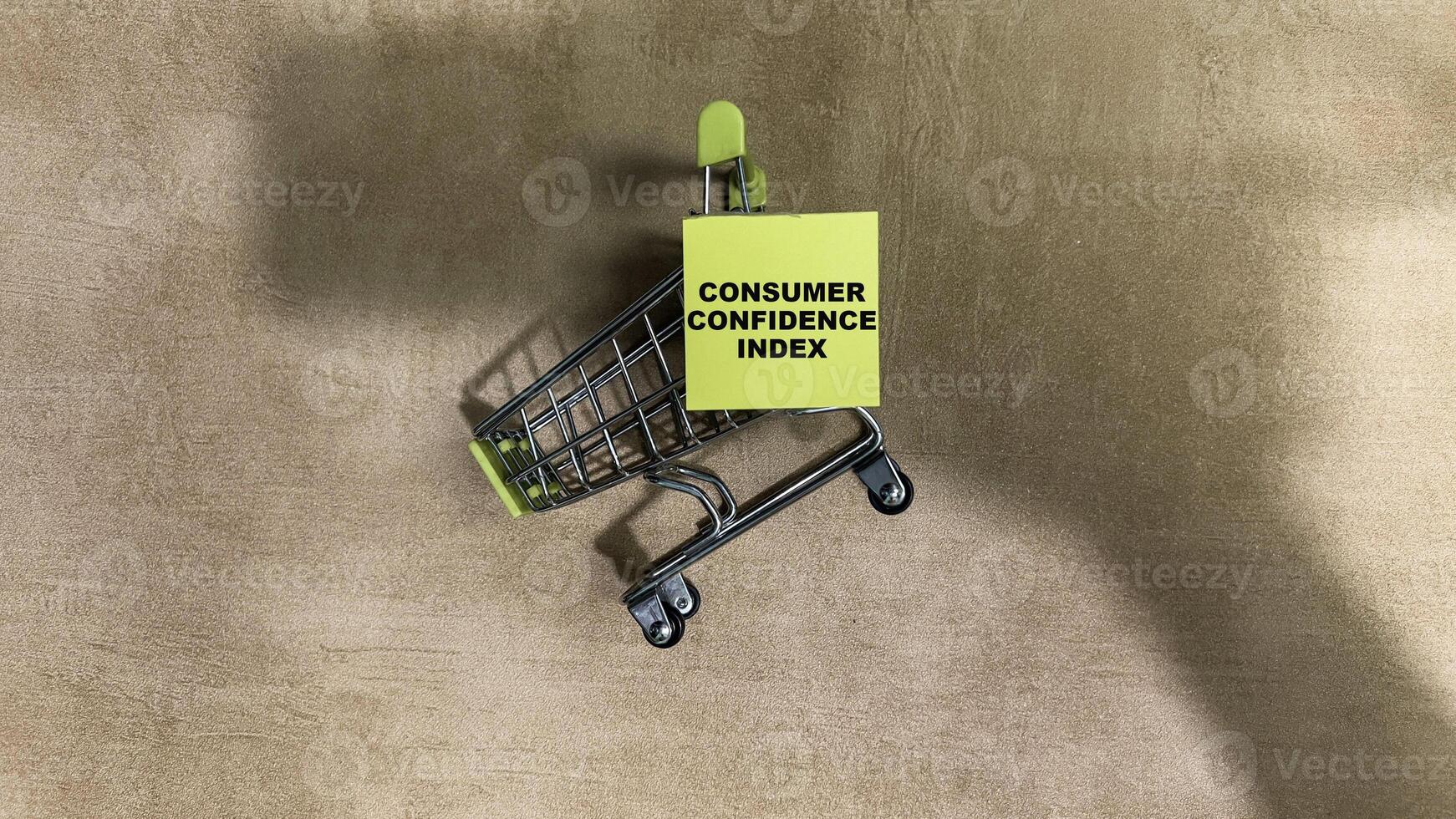 Concept of Consumer Confidence write on sticky notes isolated on Wooden Table. photo
