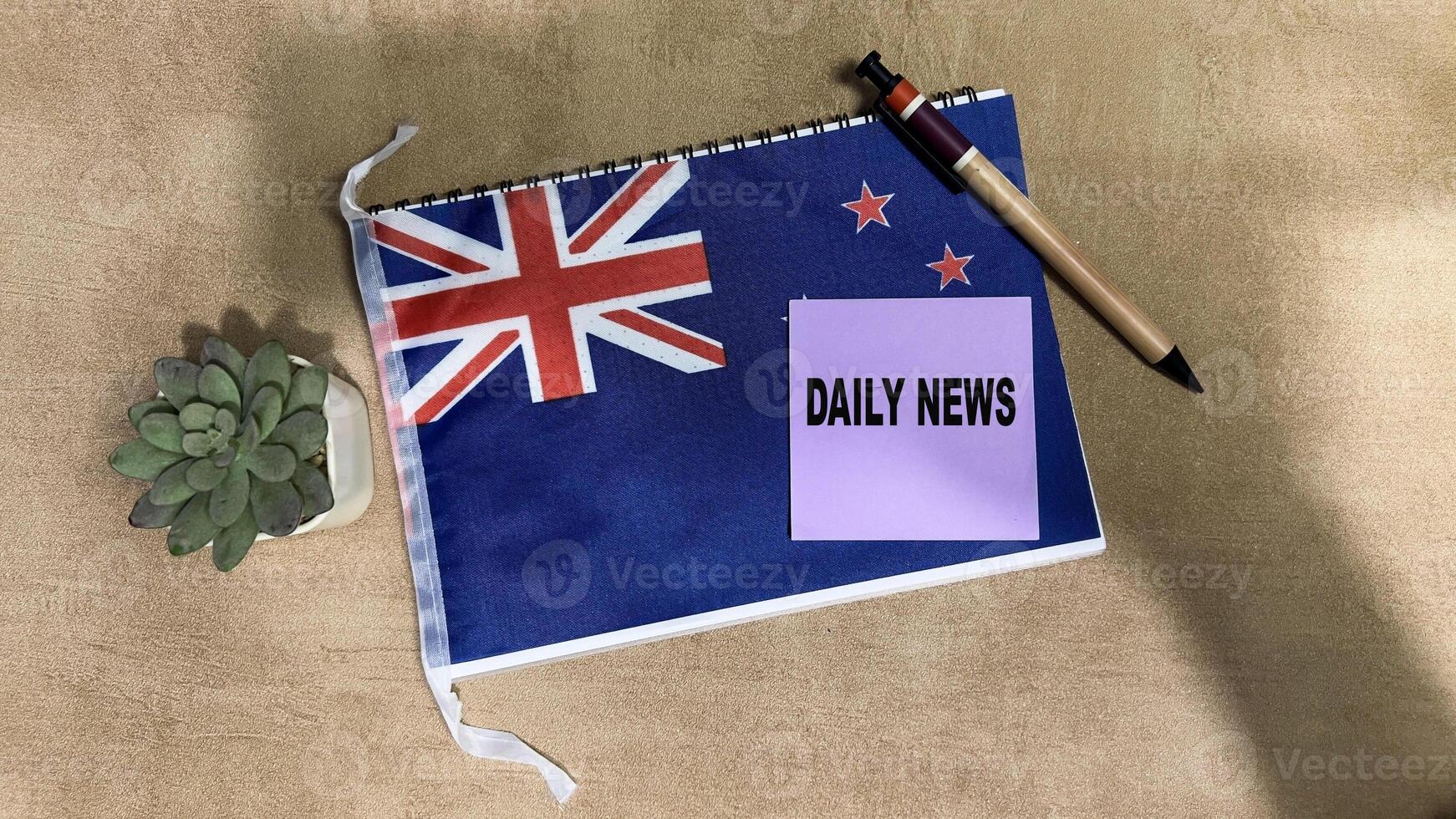 Concept of Daily News write on sticky notes isolated on Wooden Table. photo