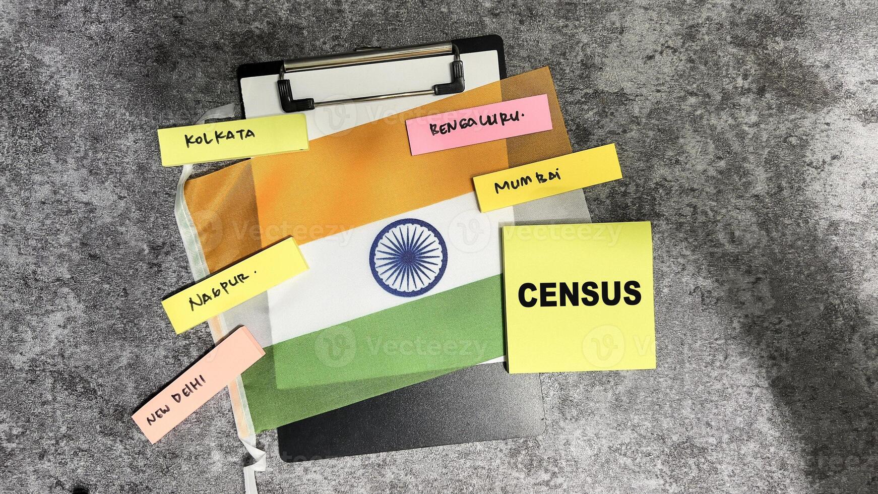 Concept of Census write on sticky notes and Flag of the India isolated on Wooden Table. photo