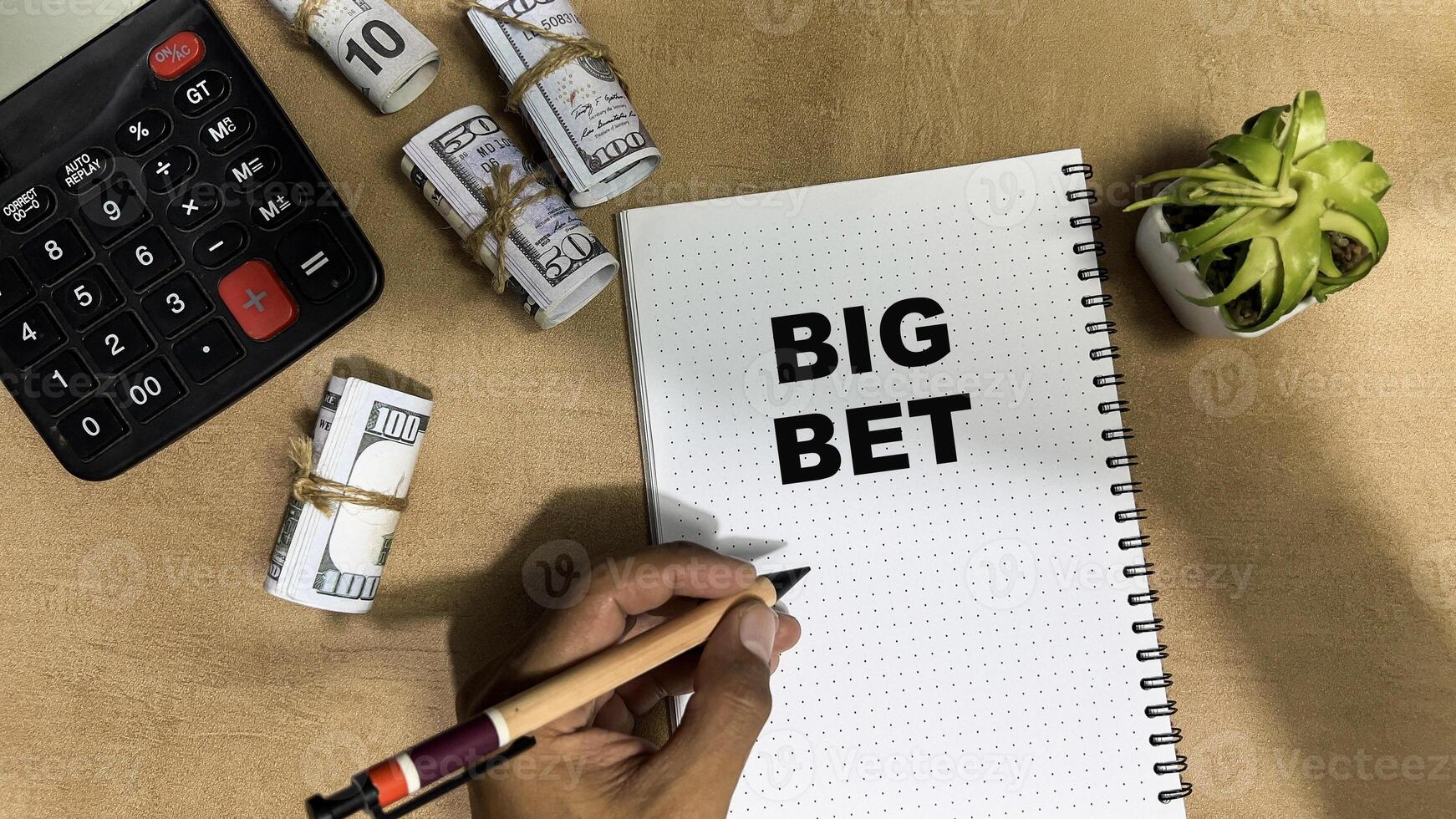 Concept of Big Bet write on book isolated on Wooden Table. photo