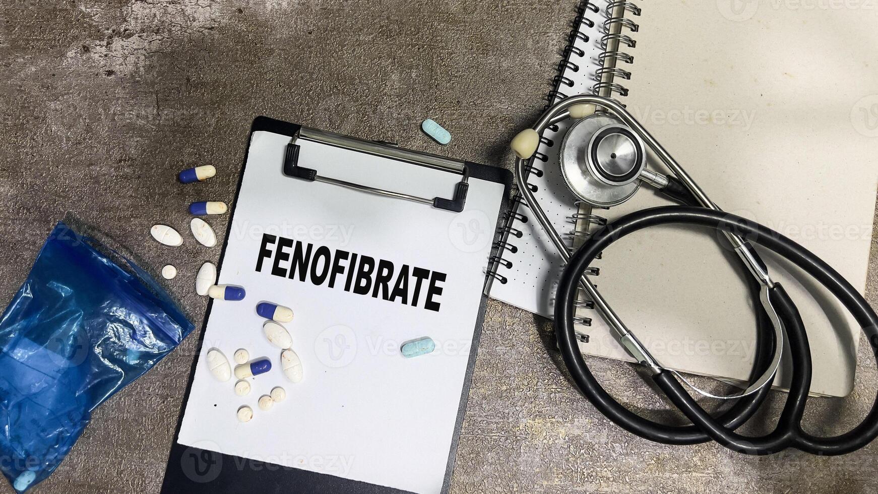 Concept of Fenofibrate write on paperwork isolated on Wooden Table. photo