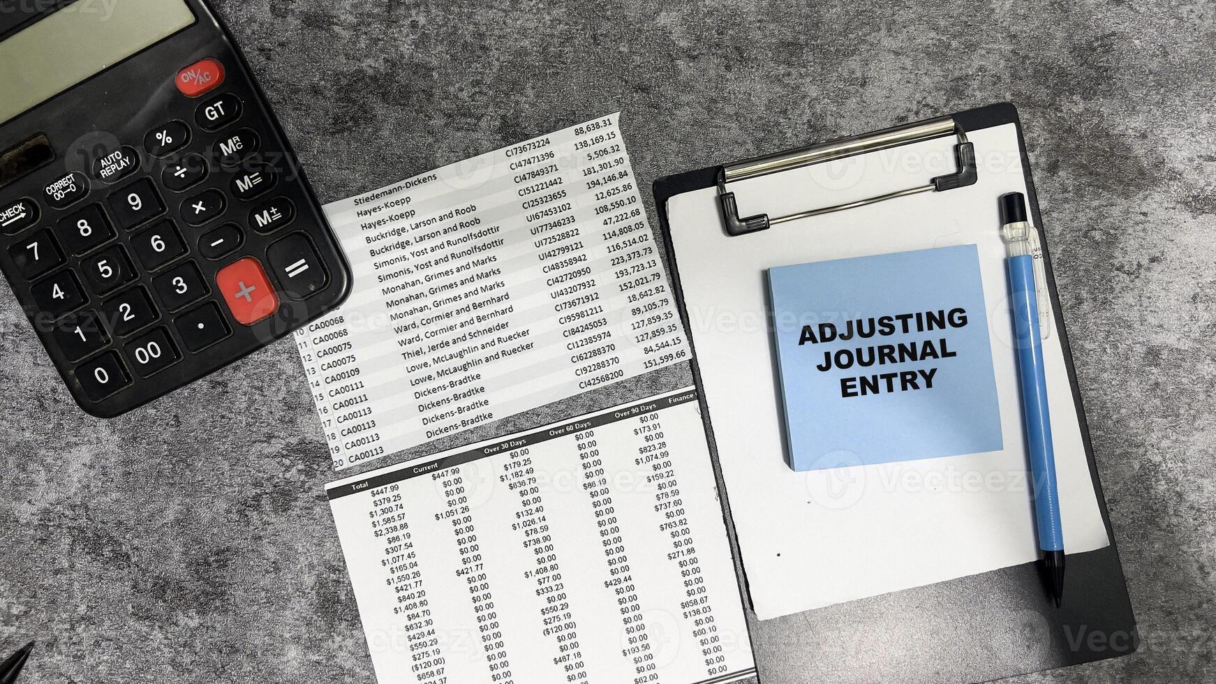 Concept of Adjusting Journal Entry write on sticky notes isolated on Wooden Table. photo