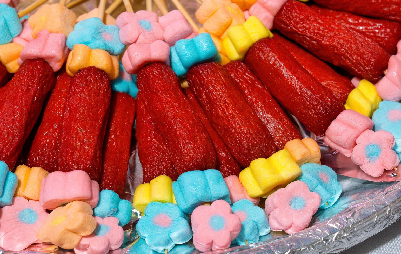 a close up of hotdogs and marshmallow skewers for a children's party photo