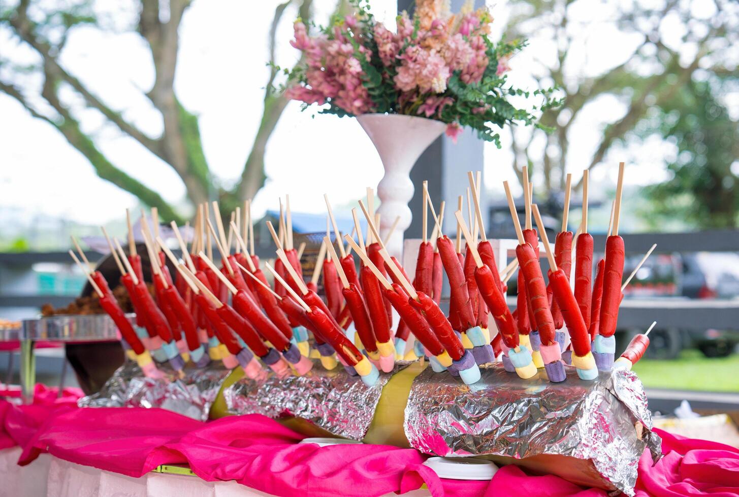 hotdogs and marshmallow skewers on a banana trunk photo