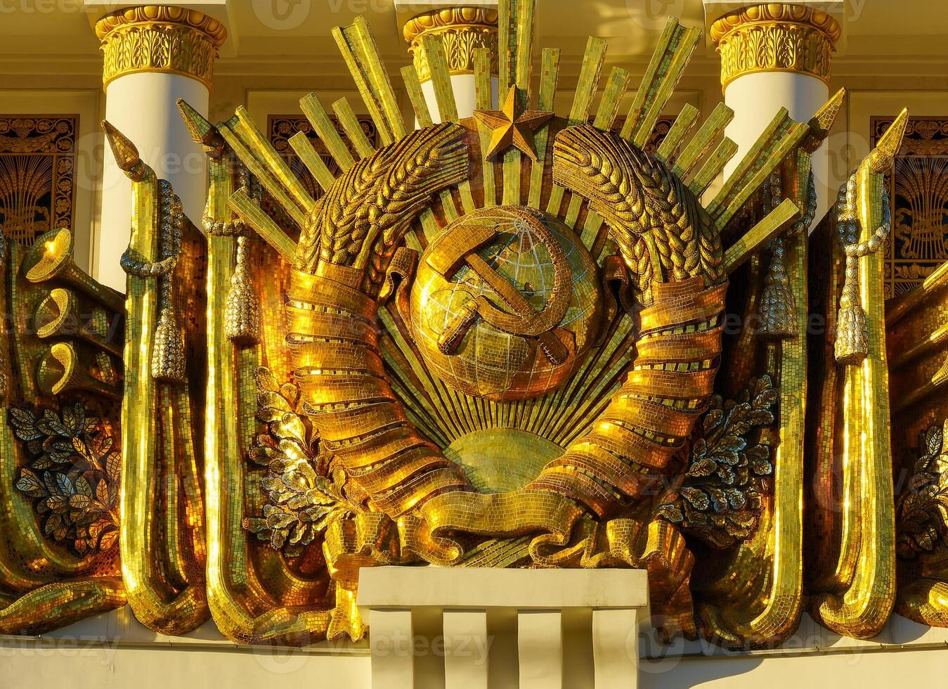 A golden statue of a man with a crown on top of a building photo