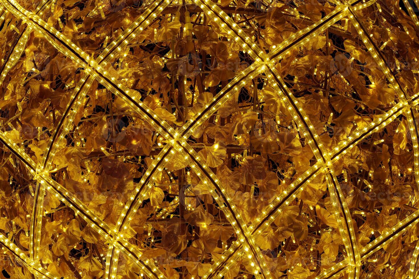 A large lighted ball with a pattern of leaves photo