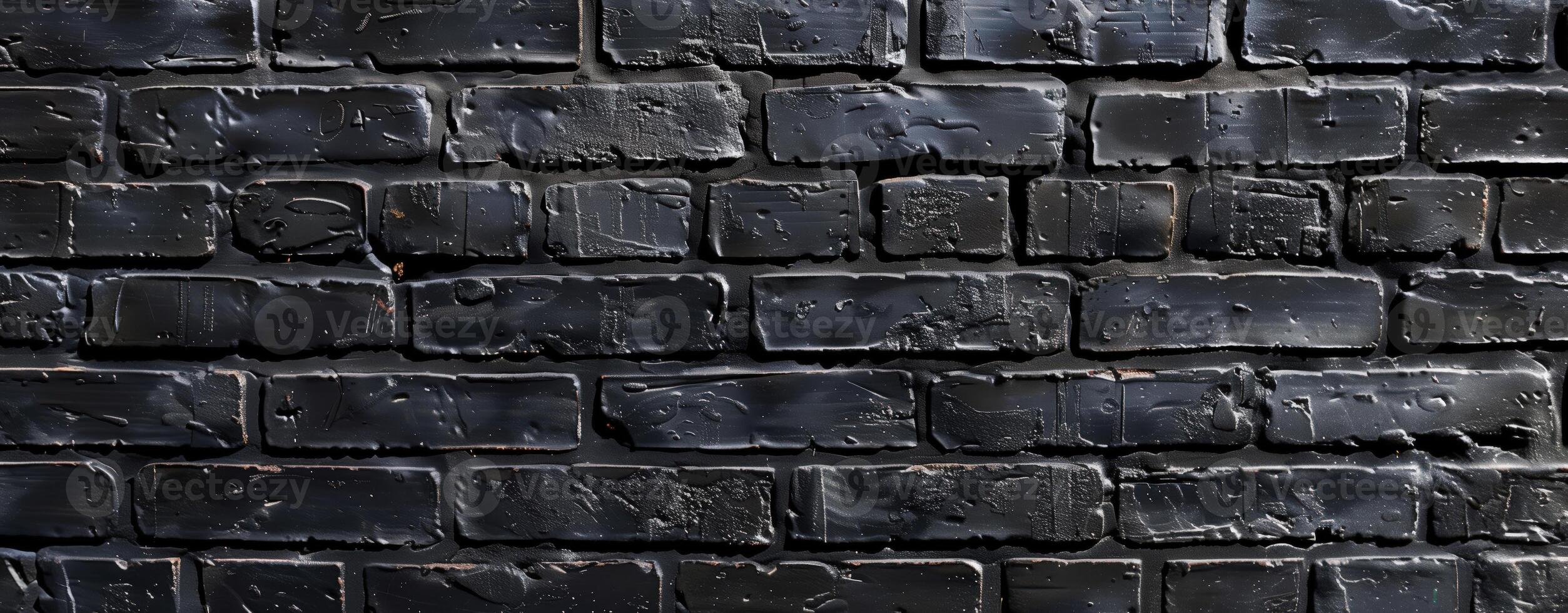 Dark bricks with glossy, uneven black coating creating an urban, textured facade. photo