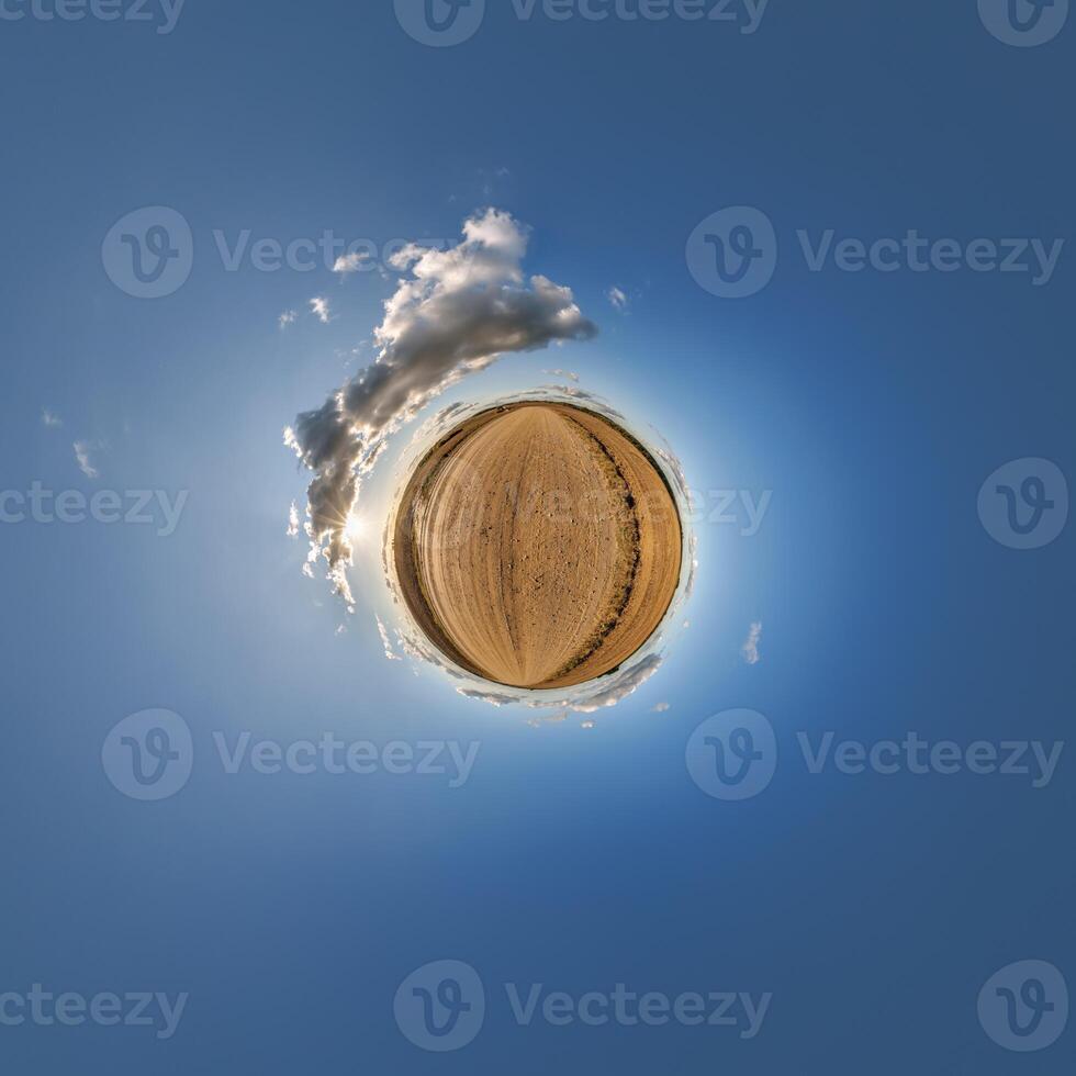A small planet with a blue sky and clouds photo