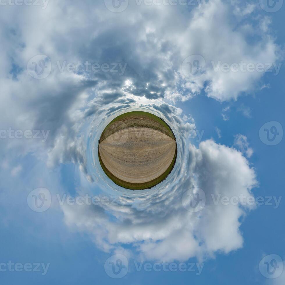 A small planet with clouds and a dirt road photo