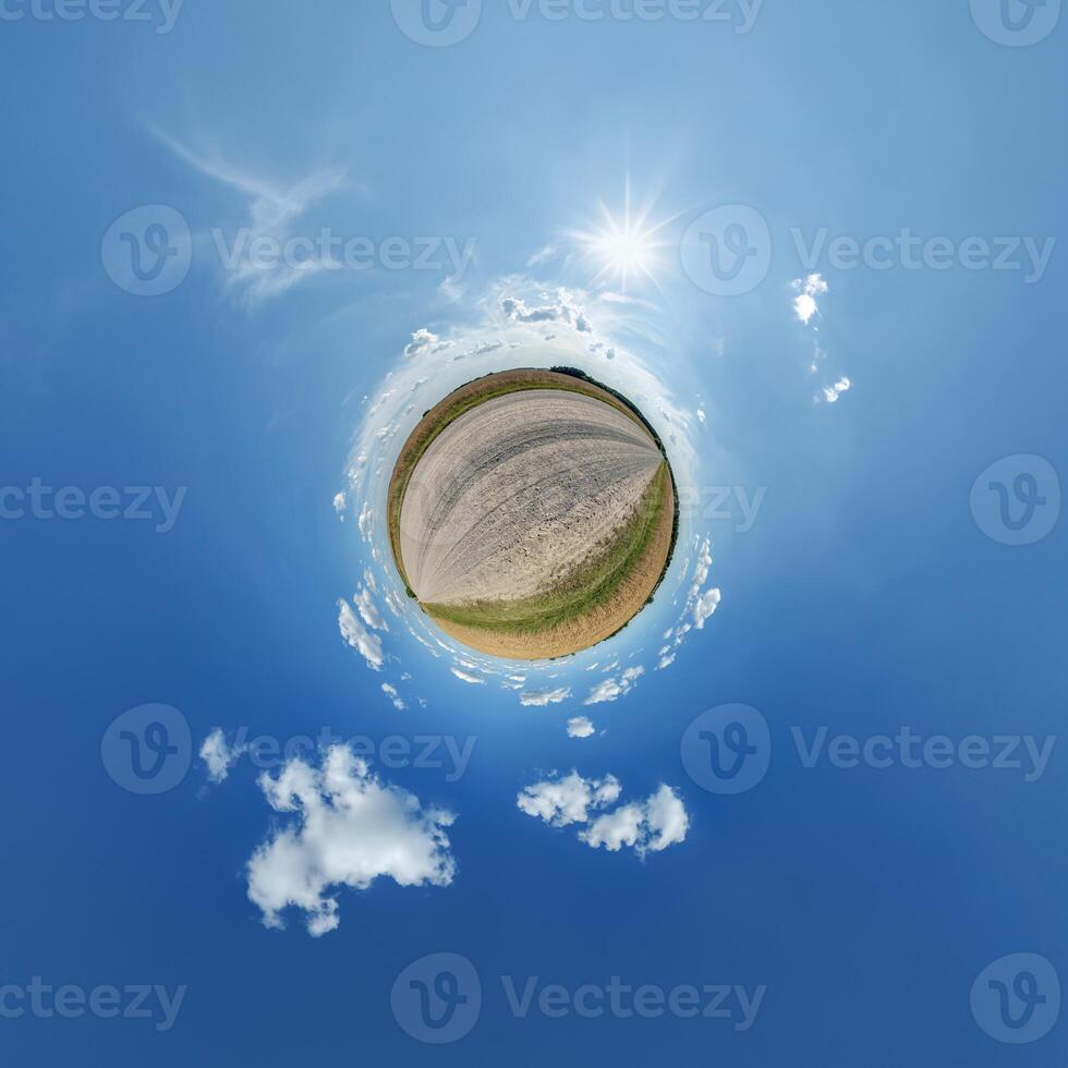 A small planet with a blue sky and clouds photo