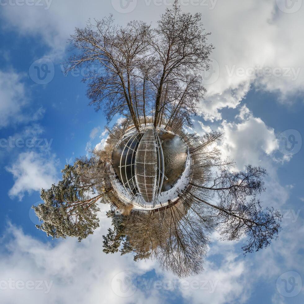 A small planet with trees and a building photo