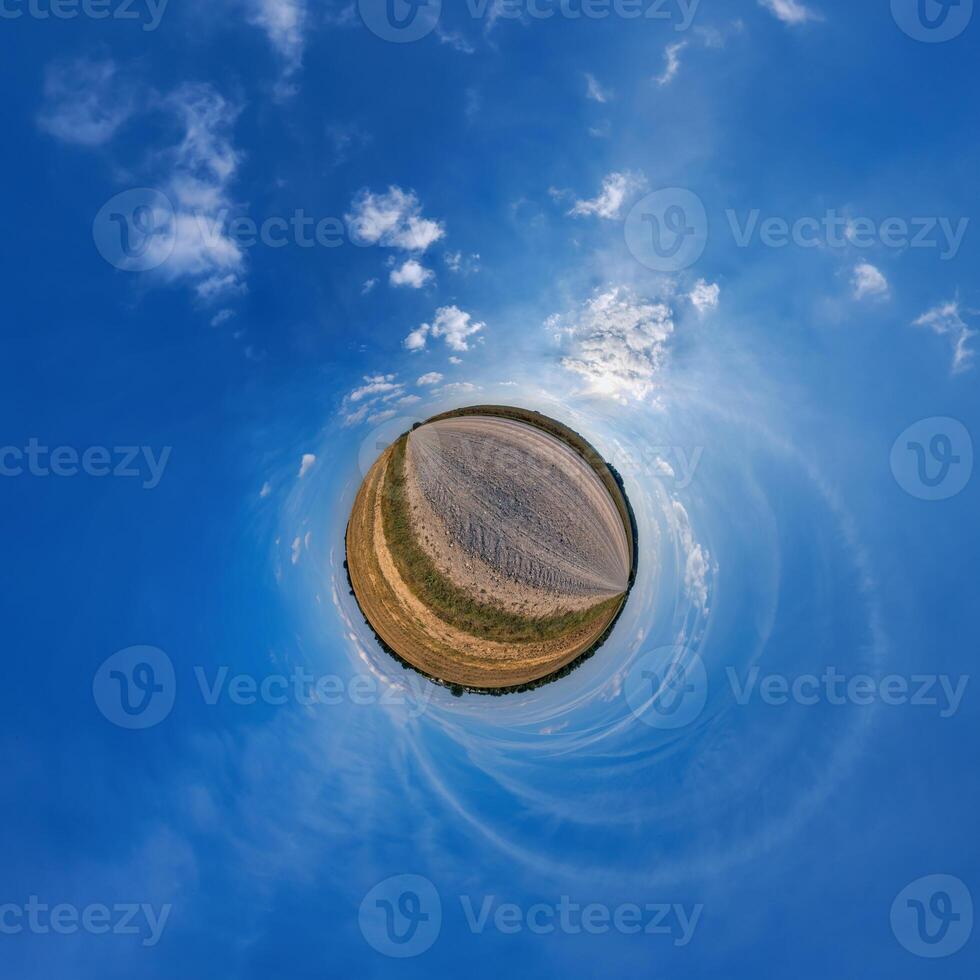 A small planet with a blue sky and clouds photo