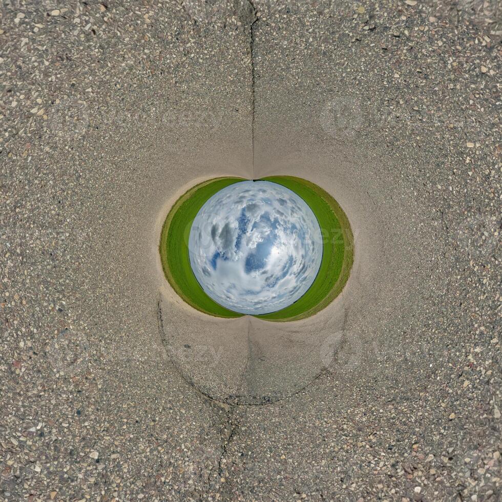 A view of a green earth through a hole in the ground photo