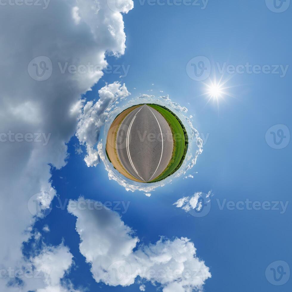 A small planet with a road and clouds photo