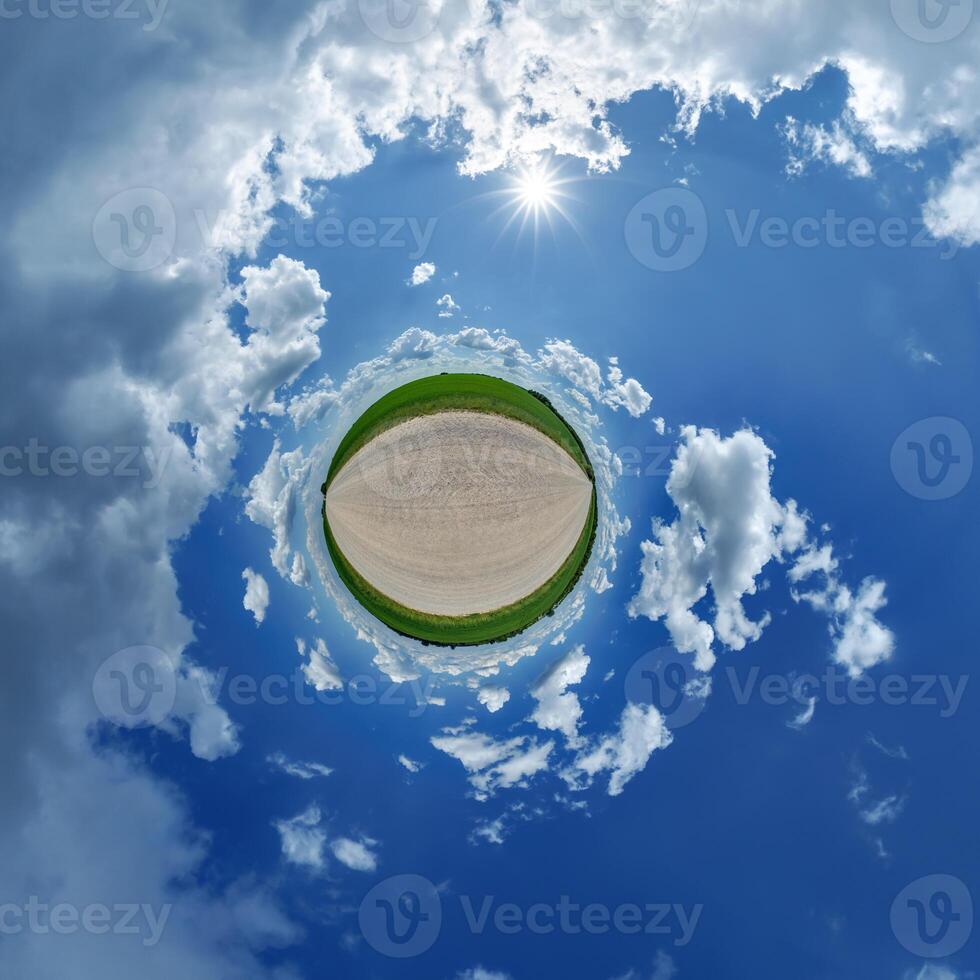 A small planet with a blue sky and clouds photo
