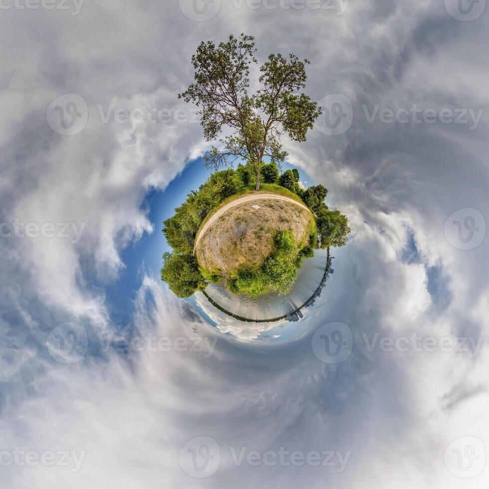A small planet with a tree in the middle photo