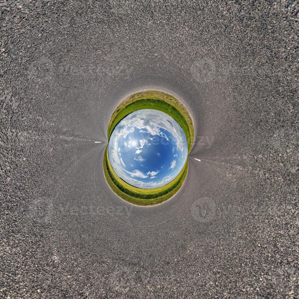 A circular hole in the ground with a blue sky photo