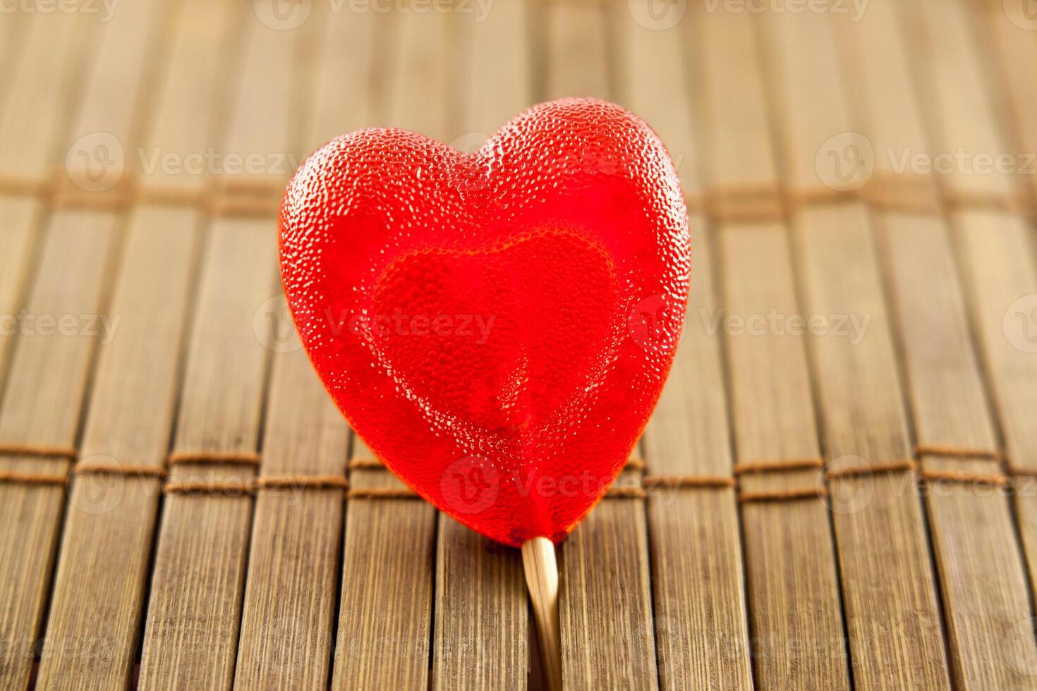 Valentine day. heart shaped lolly pop on wood background photo