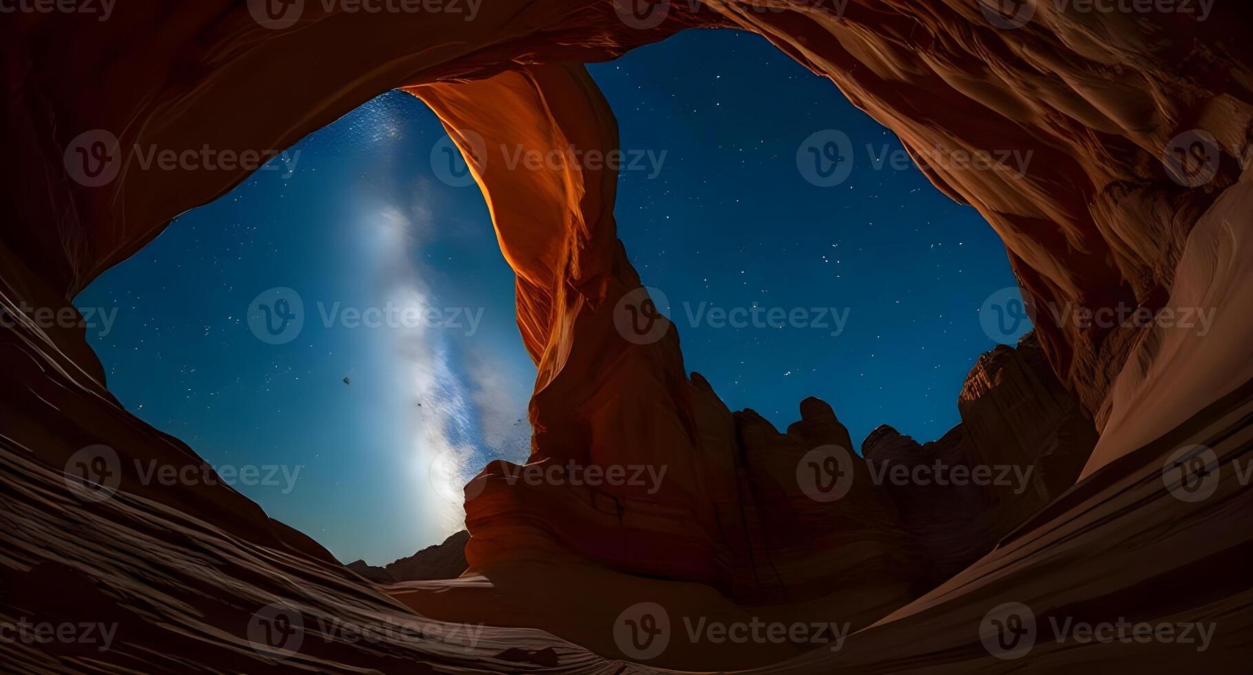 The milky way shines through the arch of a canyon photo