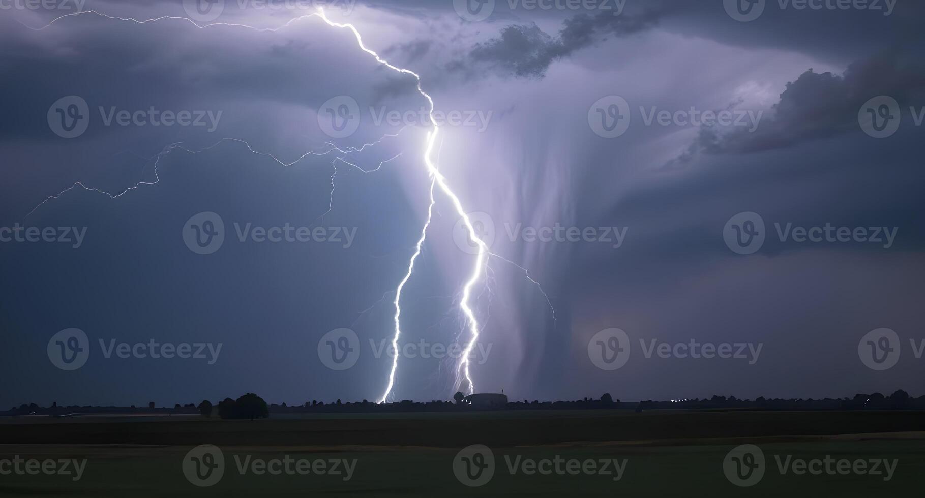 Lightning strikes over a field in the middle of a storm photo