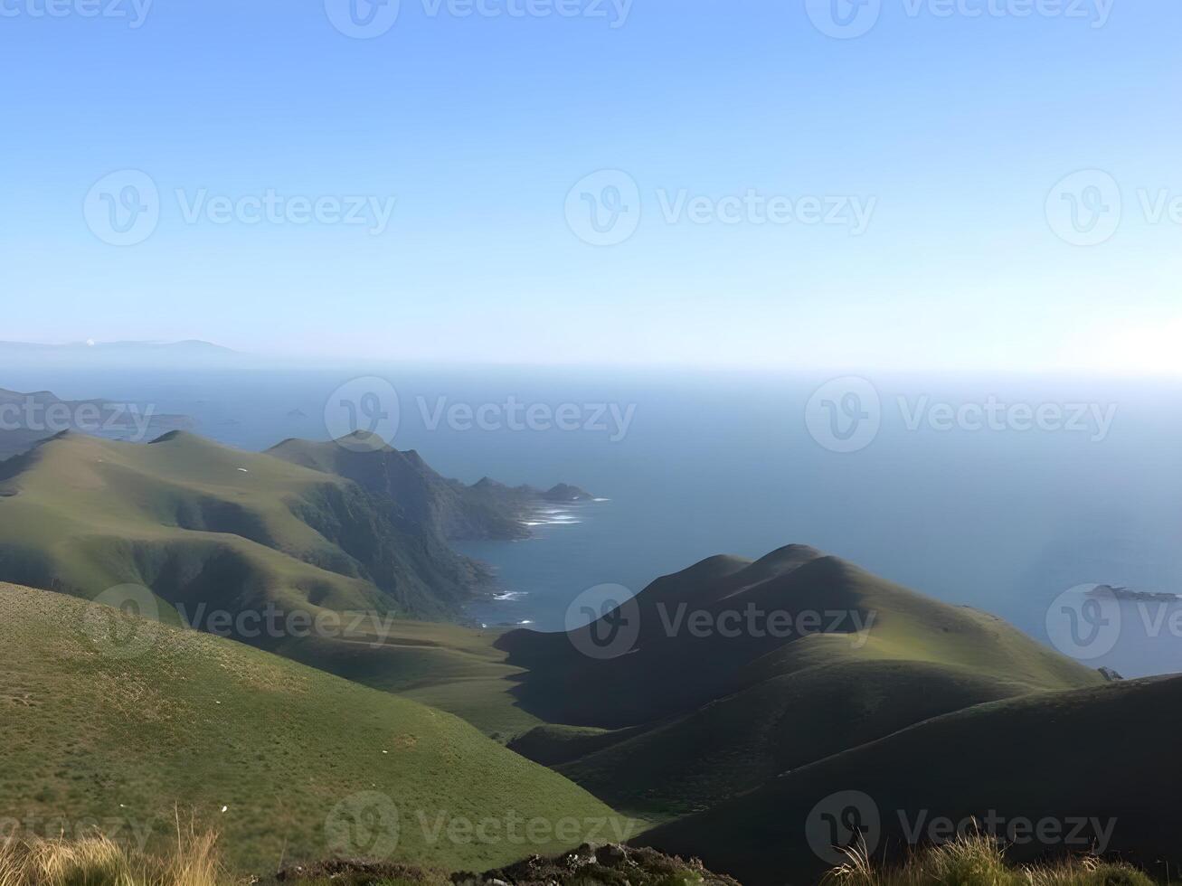 A view of the ocean and hills from a mountain photo