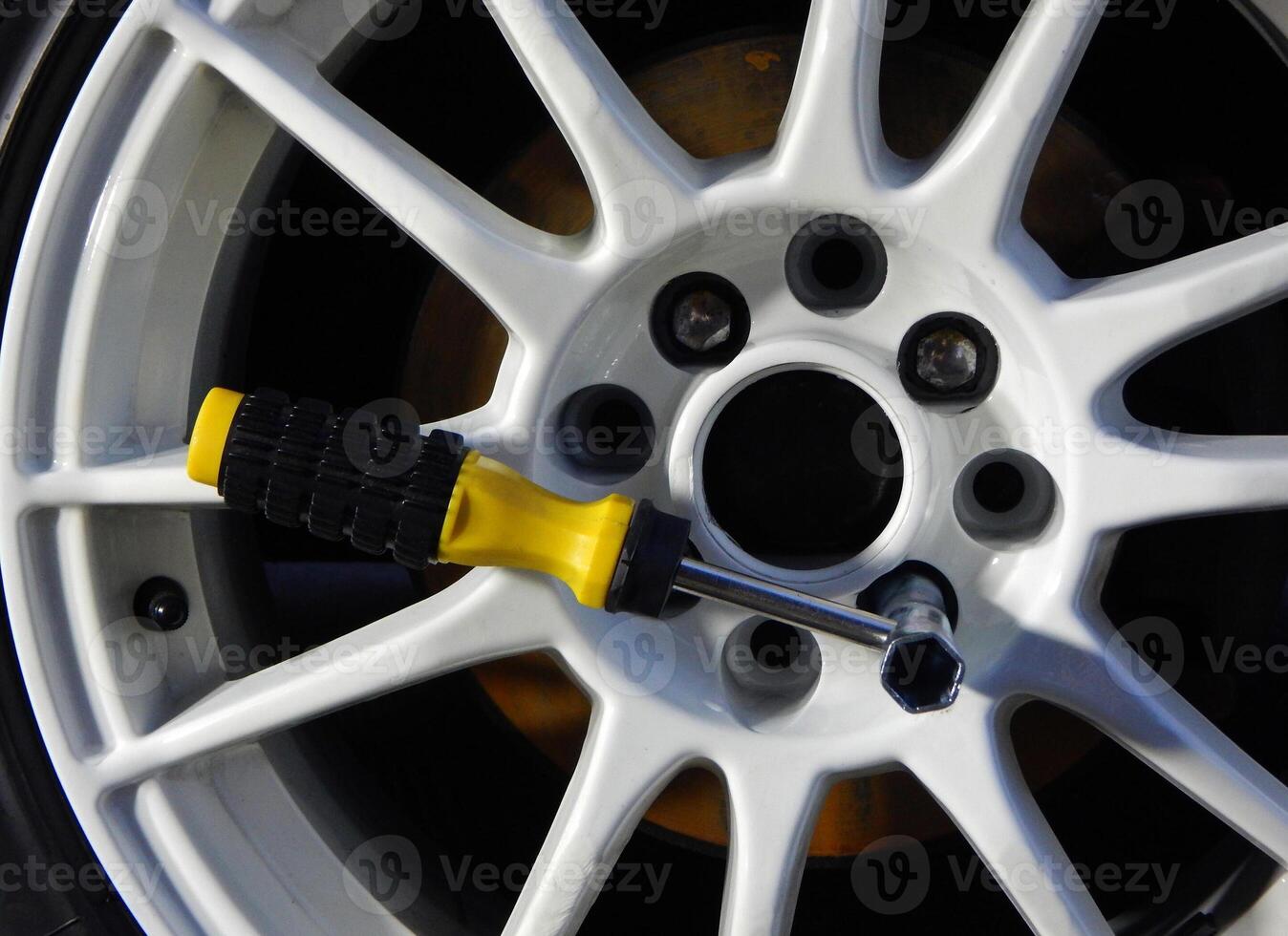 Wheel Wrench For Mounting Car Rim Inserted In Wheel photo
