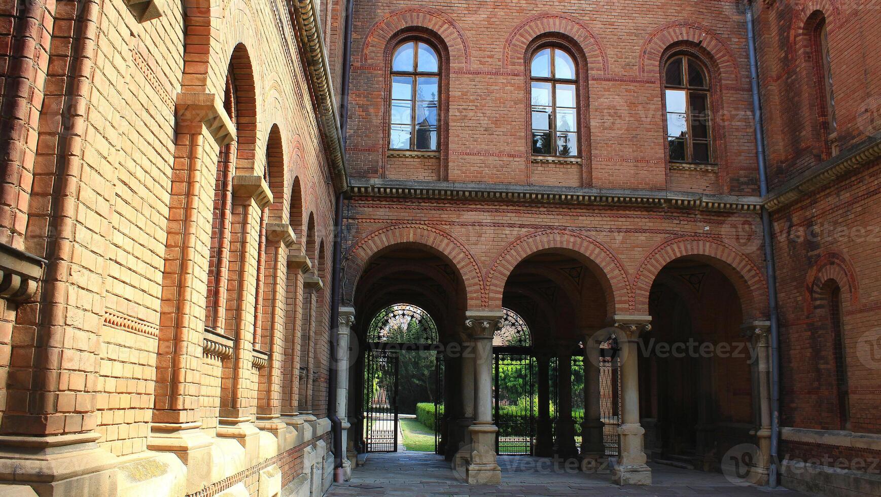 Colonnade And Forged Gate At Inner Courtyard Of Ancient Castle photo