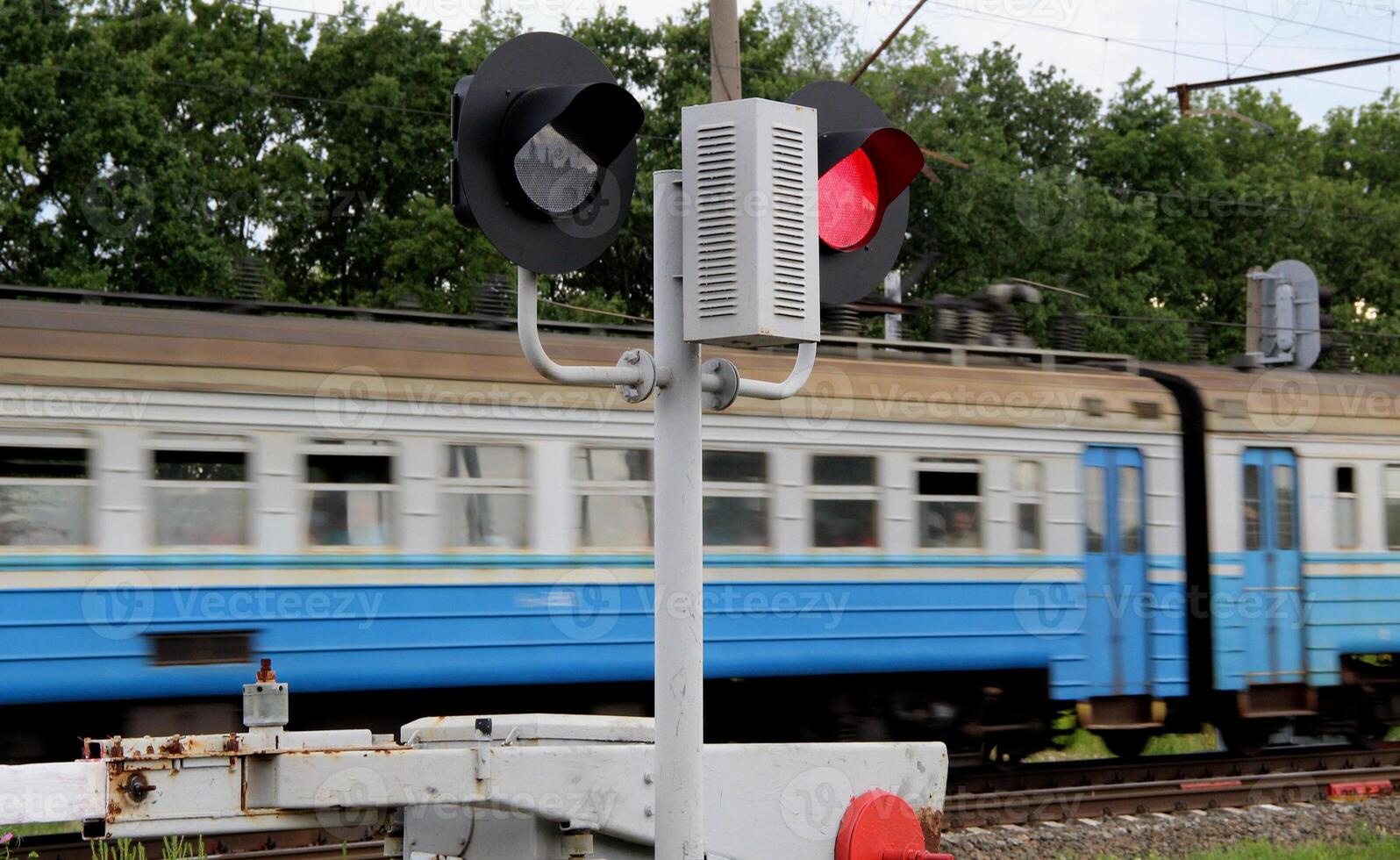 Train Car Passes A Closed Barrier At A Railway Crossing photo
