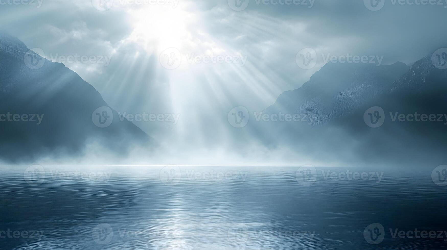 Serene landscape with mountains, water, and ethereal light rays piercing through the mist photo