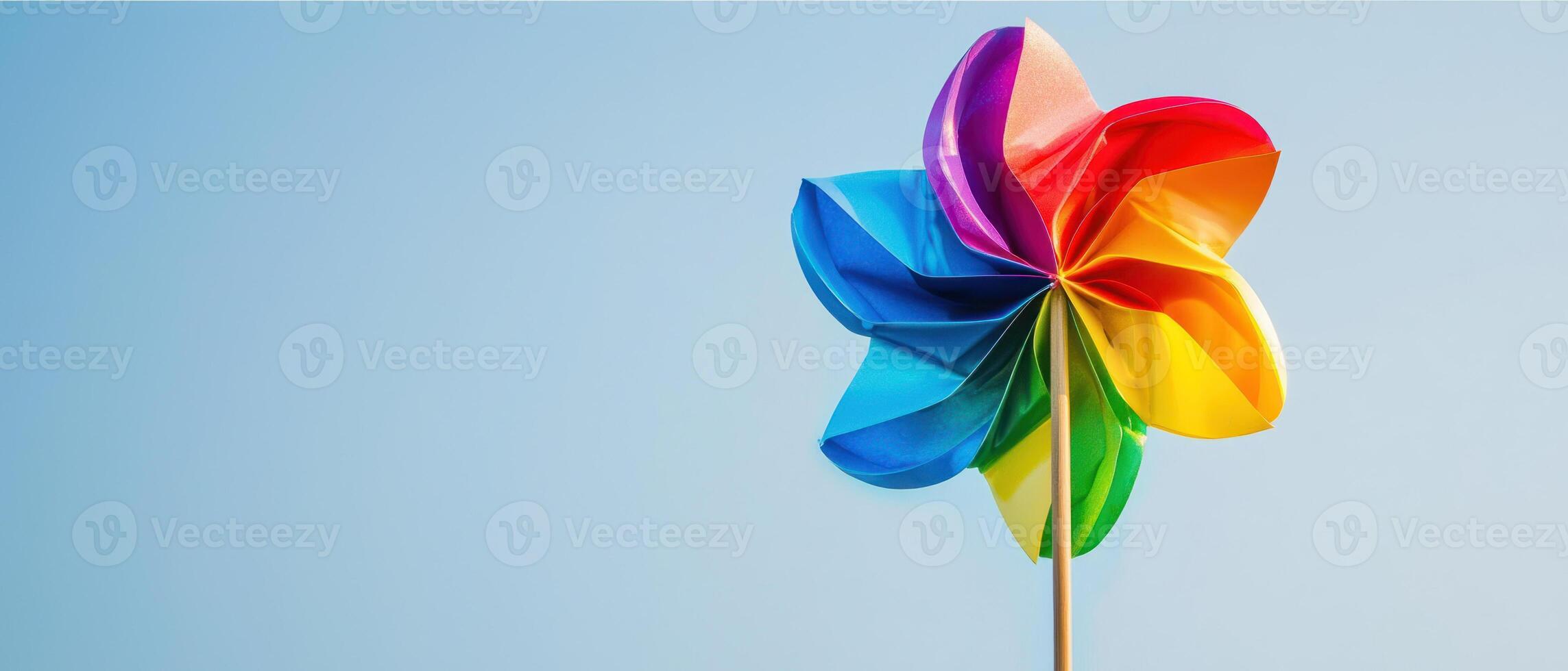 Rainbow pinwheel spinning in breeze, proud symbol of joy and color photo