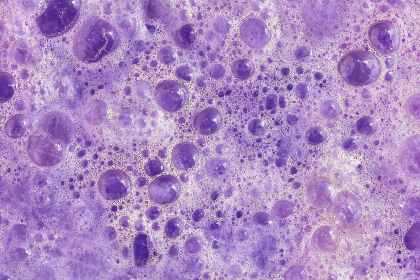 A close up of a purple surface with bubbles photo