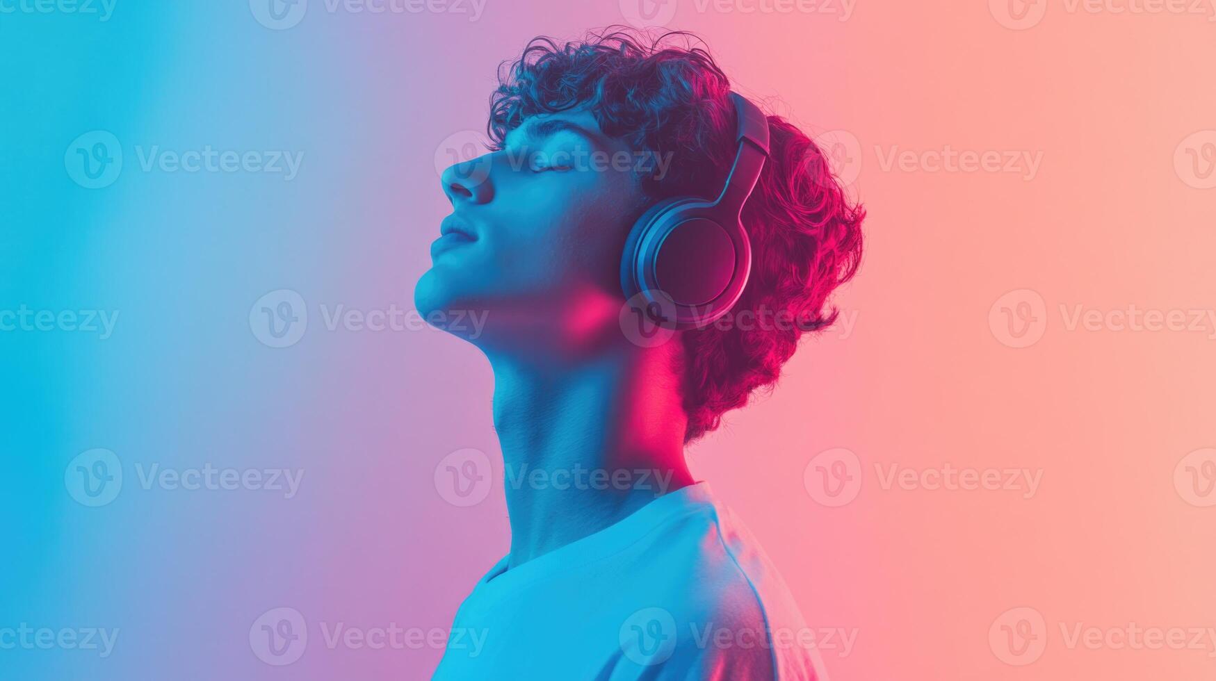 A man wearing headphones and looking up photo