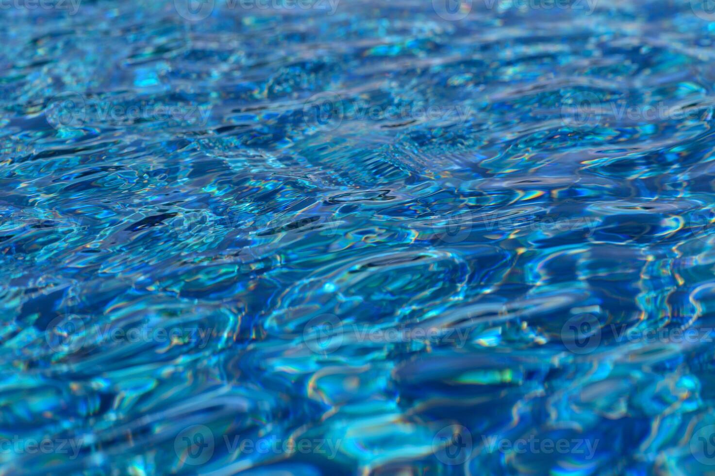 Sparkling turquoise ripples dance under sunlight in a serene swimming pool oasis photo