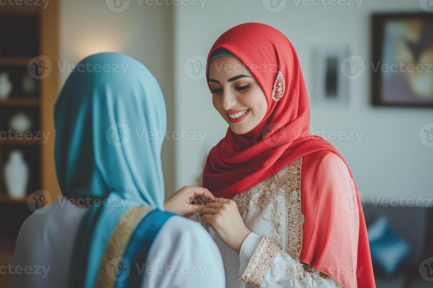 Two women in traditional clothing are smiling at each other photo